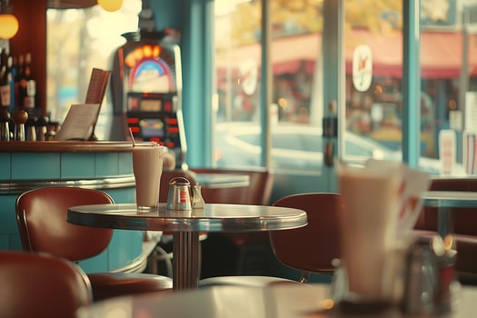 A restaurant with tables and chairs in front of a window photo