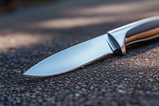 Knife lies on the road close up. Selective focus. Shallow depth of field. photo