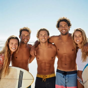 A group of young people posing for a photo on the beach
