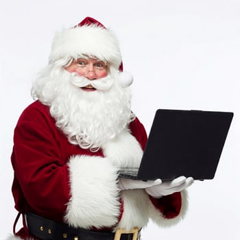 Santa claus holding a laptop computer photo