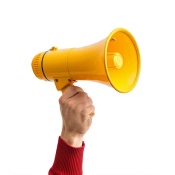 A person holding a yellow megaphone on a white background photo