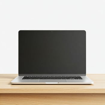 Laptop on wooden table with blank screen photo