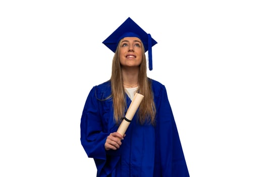 Graduated student looking up and holding diploma, wearing blue gown and graduation cap photo