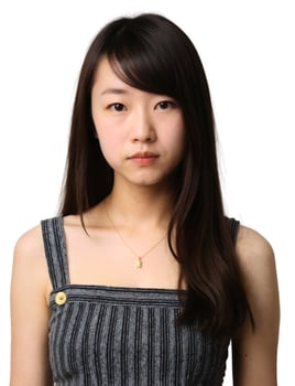 An asian woman with long hair and a black top photo