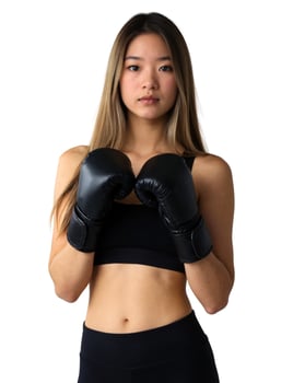 A young woman in black boxing gloves photo