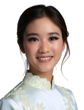 A young woman in a white dress smiling photo