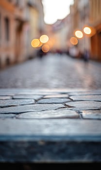 Ancient cobblestone street under blurred lights, evoking a sense of timeless urban exploration photo