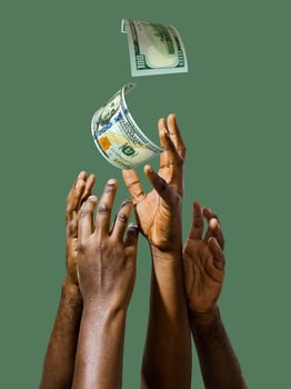 Many black African hands reaching out for United States Dollar notes money over green background.Stretching arms for cash photo