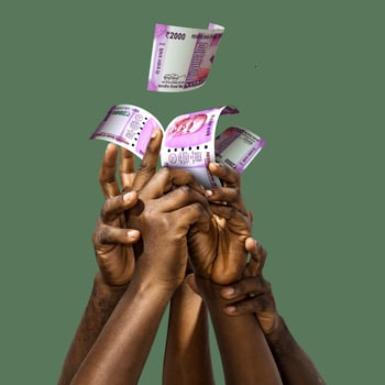 Many black African hands reaching out for Indian Rupee notes money over green background. Stretching arms for cash photo