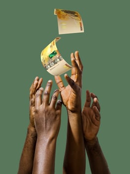 Many black African hands reaching out for Ugandan shilling notes money over green background. Stretching arms for cash photo