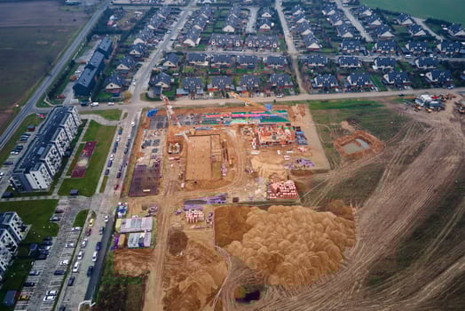 Construction site with cranes building new houses, aerial top view photo