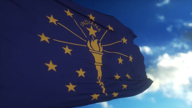 Indiana flag on a flagpole waving in the wind in the sky. State of Indiana in The United States of America. 3d illustration photo