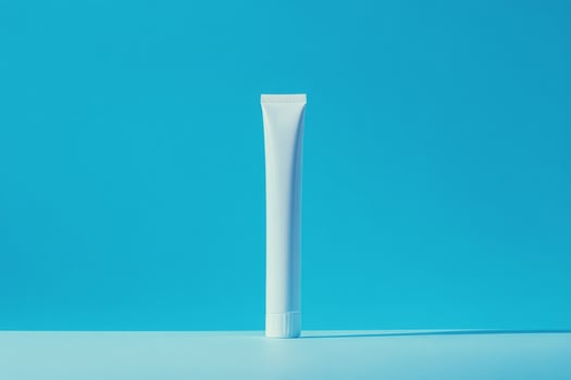 A tube of toothpaste on a blue background photo
