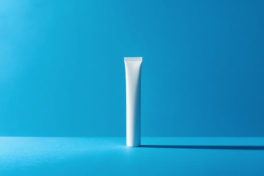 A tube of toothpaste on a blue background photo