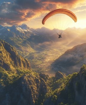 Paraglider flying over the mountains at sunset photo