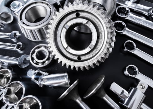 Collection of metallic tools and mechanical components arranged on a black surface showcasing craftsmanship and precision photo