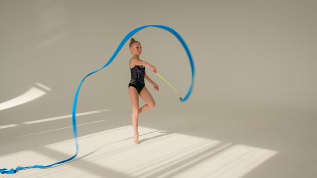 Caucasian woman schoolgirl kid daughter child little girl artistic female ballet dancer sportswoman young athlete teenager gymnast spinning dancing with tape sport gymnastics dance studio choreography photo