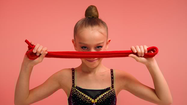 Little girl sportswoman female gymnast acrobat ballerina dancer with skipping rope in pink studio sport class education strong serious child looking camera kid daughter schoolgirl teen workout ballet photo