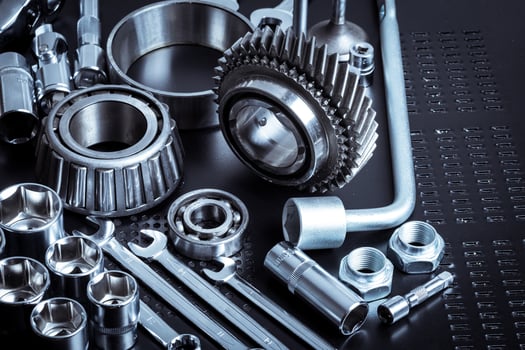 Metal tools and mechanical components arranged on a dark surface showcasing precision and engineering photo