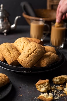 arabic kaak biscuits with coffee on black plate photo