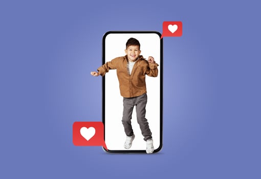 A young child joyfully dances inside a smartphone screen surrounded by heart icons. The vibrant setting showcases enthusiasm and connection through technology, perfect for Valentines Day. photo
