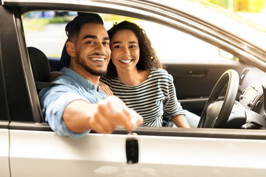 Happy young middle-eastern couple showing key from new car, smiling arab man and woman sitting inside new luxury auto, copy space. Car renting, leasing, buying, dealership, auto retail concept photo