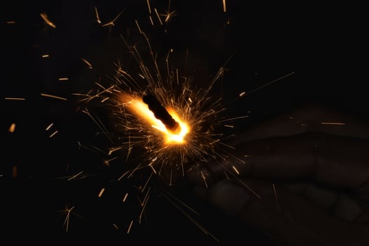 A person holding a sparkler in their hand photo
