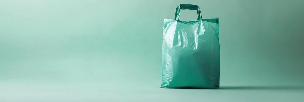 A green plastic bag sitting on top of a green background photo