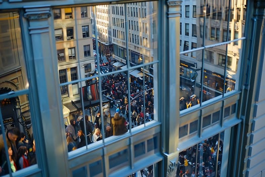 A large crowd of people walking down a street photo