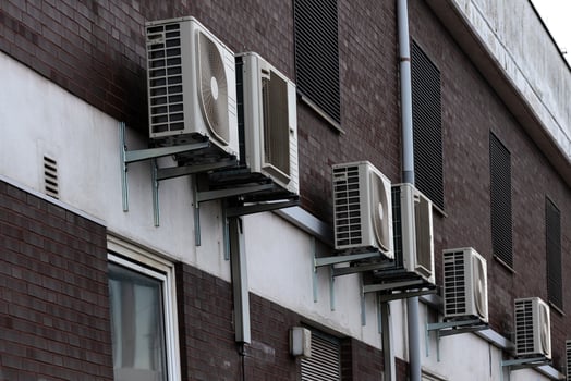 Wall-mounted air conditioning units on a residential building photo