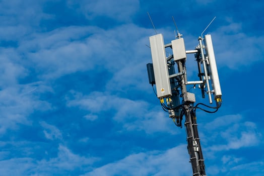 Cell tower stands tall against a clear blue sky photo