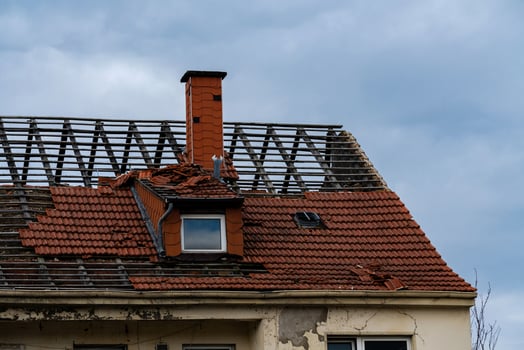 Roof damage near chimney caused by severe weather conditions photo