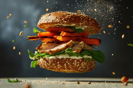 Mega sandwich with rustic whole-grain bun and vibrant toppings floating mid-air with creamy yogurt sauce drizzles photo