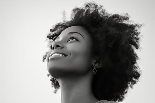 A black and white photo of a woman with curly hair