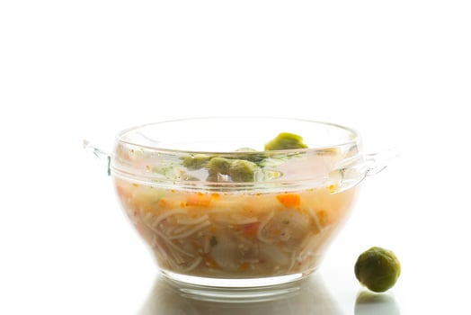 Vegetable lunch. Natural vegetable soup with brussels sprouts, isolated on white background photo