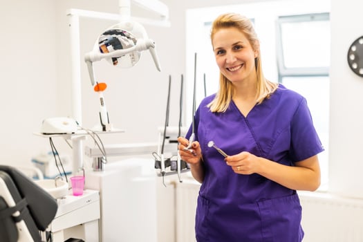 Cheerful professional dentist at work photo