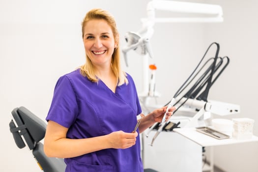 Portrait of happy dentist in her dentist's office. photo