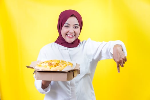 a woman in a white shirt holding and pointing down ward photo