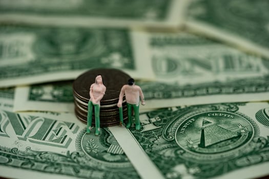two figures with US money photo