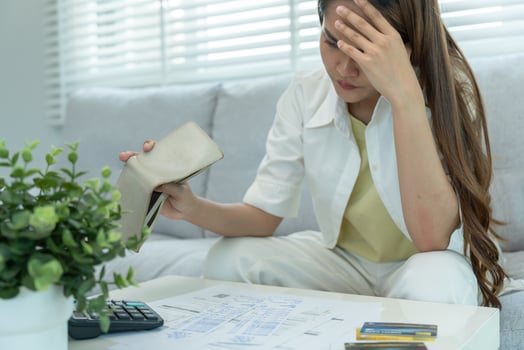 Stressed and headache asian woman with large bills or invoices no money to pay to expenses and credit card debt. shortage, Financial problems, mortgage, loan, bankruptcy, bankrupt, poor photo