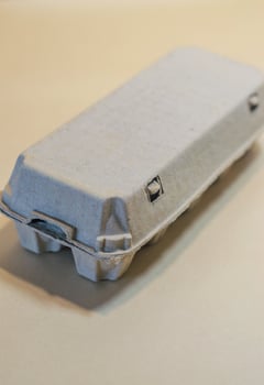 Closed Egg Carton. Top-down view of grey, recycled cardboard container. High quality photo