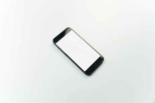 Black smartphone on white background with copy space photo