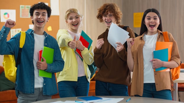 Four school Caucasian students happy smiling rejoice celebrate win victory good result pass exams pupils studying male female teamwork study learning men women girls guys college excited posing joy photo