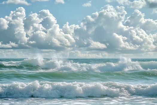 Ocean waves crashing on shore under cloudy sky photo