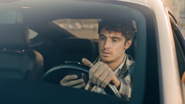 Disappointed stressed sad man Caucasian auto driver businessman inside automobile car waiting in traffic jam using mobile phone read bad news upset displeased loss gps navigation road driving in city photo