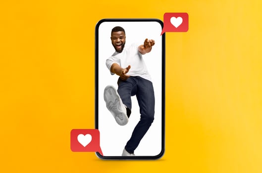 A joyful person interacts with their smartphone, expressing love and excitement. The yellow background highlights themes of social media, connection, and modern technology. photo