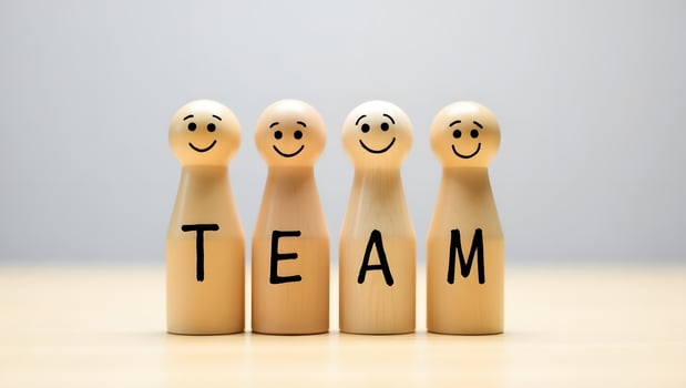 Teamwork Concept with Wooden Peg Dolls Spelling TEAM Collaboration and Unity photo