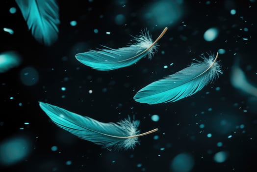 Turquoise feathers floating on a black background with glitter photo