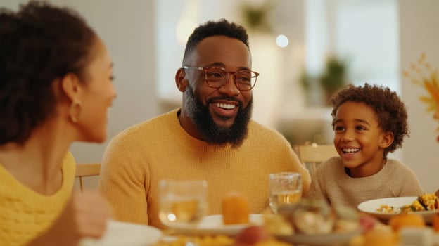 A family is smiling while sitting at a table with food photo