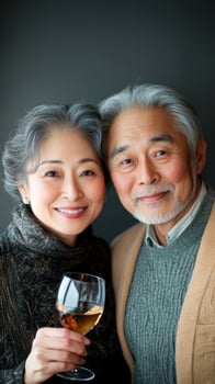An older couple holding a glass of wine photo